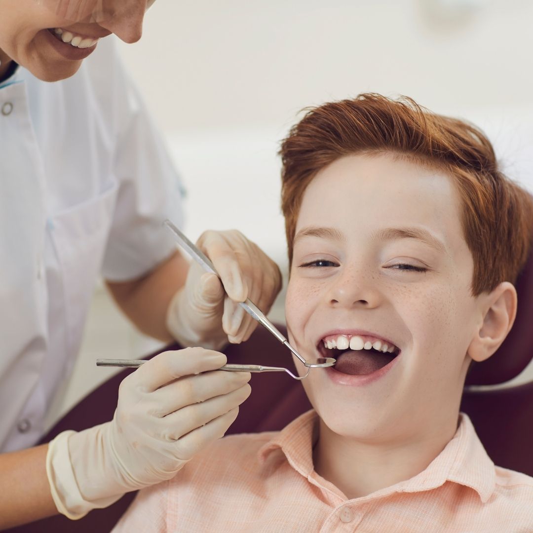 dental hygienist inspecting child's mouth