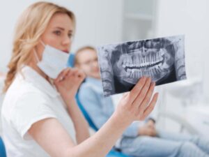 A dentist holding a tooth scan
