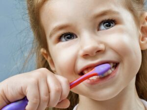 A young girl brushing her teeth