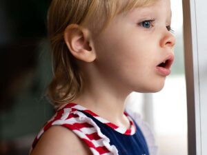A young child looking out a window